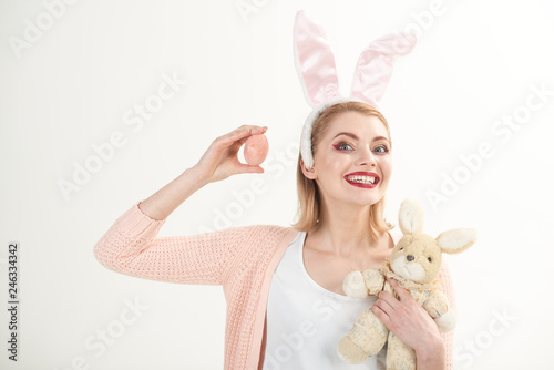 Egg hunt. Easter eggs as traditional food. Woman in rabbit bunny ears. happy woman in bunny ears with toy. Spring holiday. Girl with hare toy. Happy easter. Which one do you want