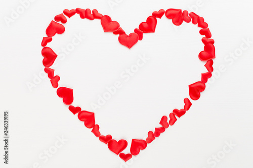Valentines day background red hearts on white wooden background.
