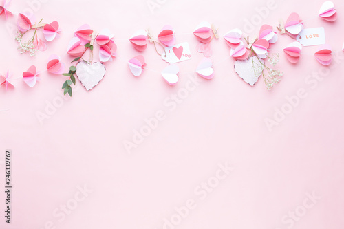 Colorful paper garland of hearts on the living coral background. Valentine day greeting cards. © gitusik