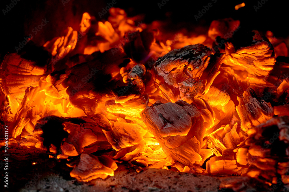 Beautiful color of burning red coals and black charred wood. Orange hot coals in the Russian stove. Red burning coals as a texture for design Beautiful color of burning red coals and black charred wood. Orange hot coals in the Russian stove. Red burning coals as a texture for design