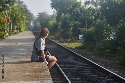 The girl is sitting at the station of the railway station. Sri-lanka © Dima Anikin