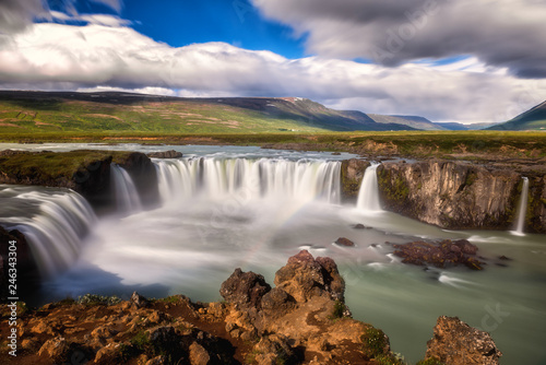 Godafoss  Akureyri  waterfall at sunny day  spectacular landscape of Iceland iconic place with blue cloudy sky  long exposure. Skjalfandafljot river  Nor  urland  North of Iceland