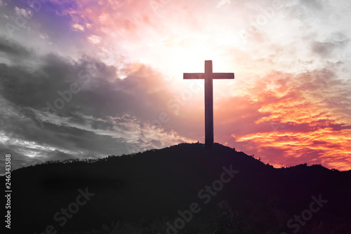  Concept of Jesus Christ: white cross on sunset sky background © paul