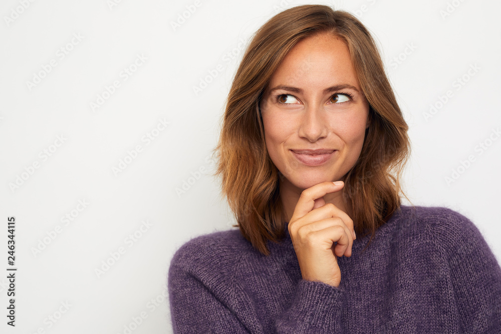 portrait of a young happy woman smiling and thinking on white background portrait of a young happy woman smiling and thinking on white background