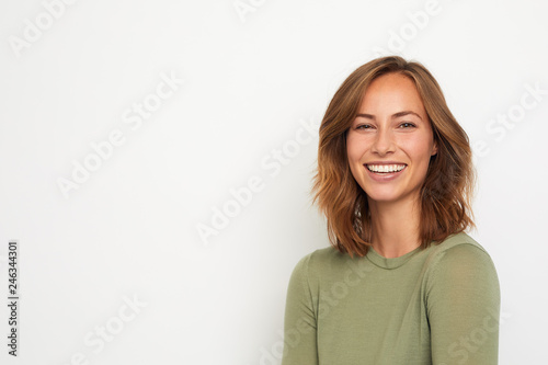 portrait of a young happy woman smiling on white background