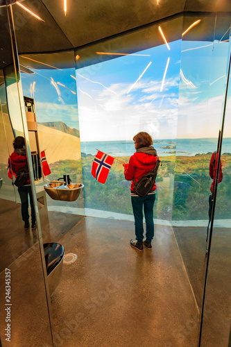 Tourist with norwegian flag in mirrored toilet, Andoy Norway photo