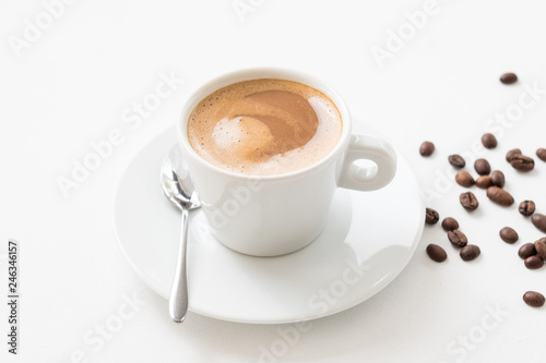 Morning hot coffee wake up concept. Latte cup and beans on white background.
