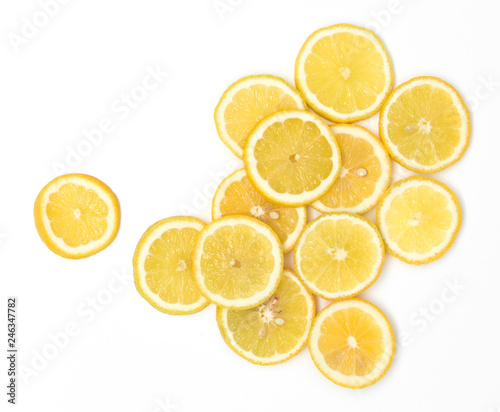 many fresh lemon slices lie beautifully arranged on a white background