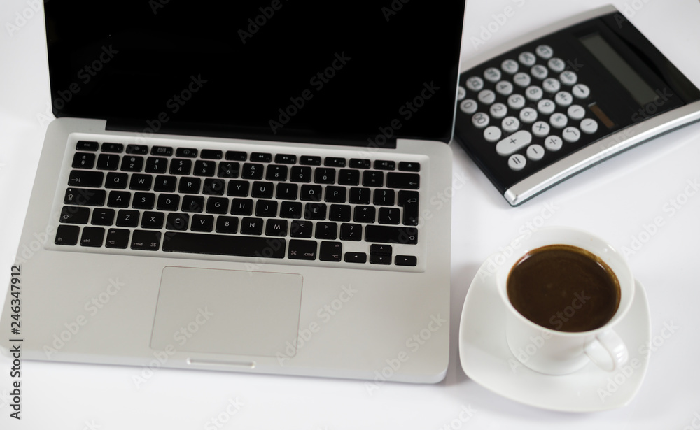 Business work place with cup of coffee calculator and Computer laptop Business work place with cup of coffee calculator and Computer laptop