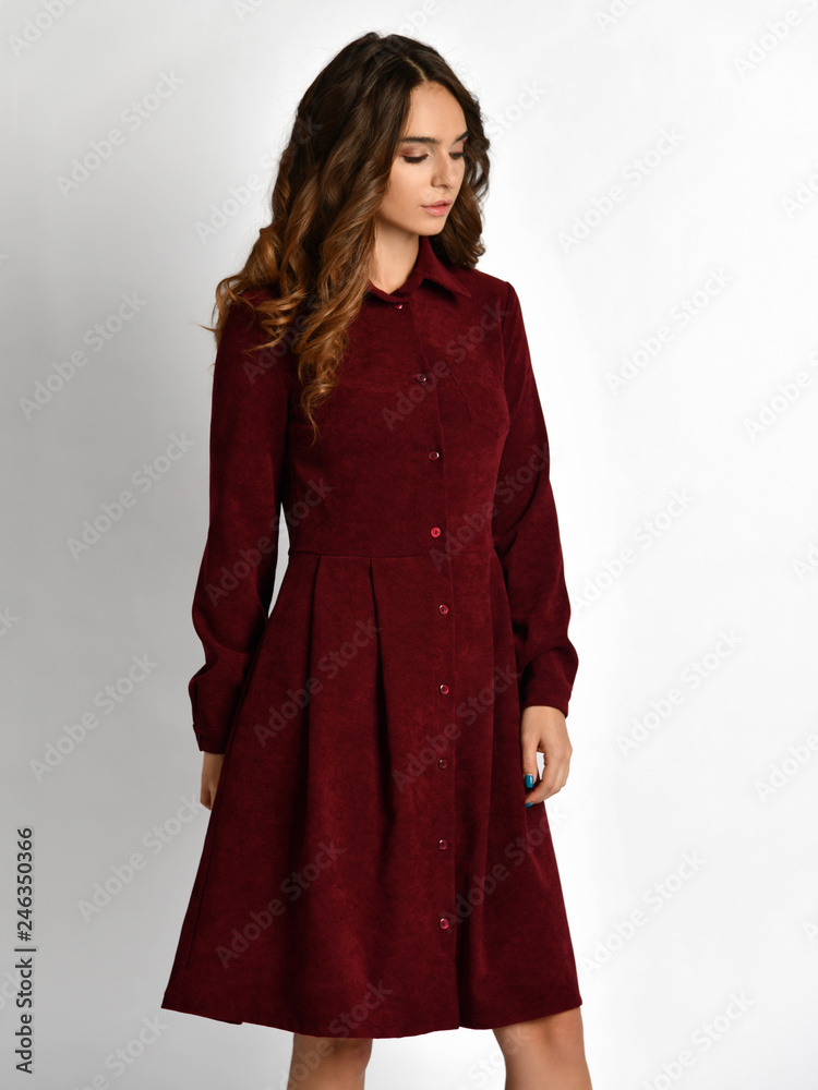 Young beautiful woman posing in new fashion red pattern winter dress Young beautiful woman posing in new fashion red pattern winter dress