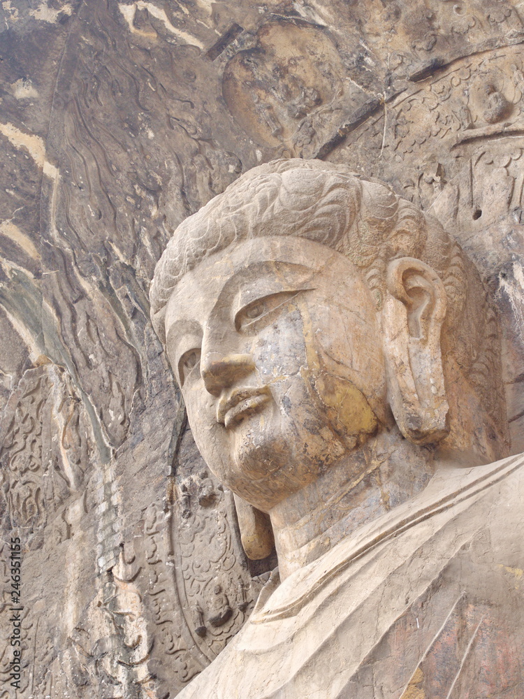 Fototapeta premium Luoyang Longmen grottoes. Broken Buddha and the stone caves and sculptures in the Longmen Grottoes in Luoyang, China. Taken in 14th October 2018