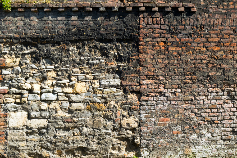 Old neglected stone and brick wall full frame background texture Old neglected stone and brick wall full frame background texture