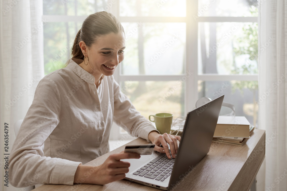 Happy woman doing online shopping at home Happy woman doing online shopping at home