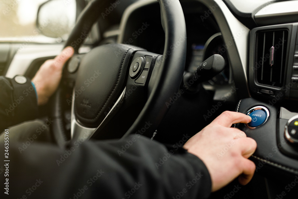 Car driver starting the engine.