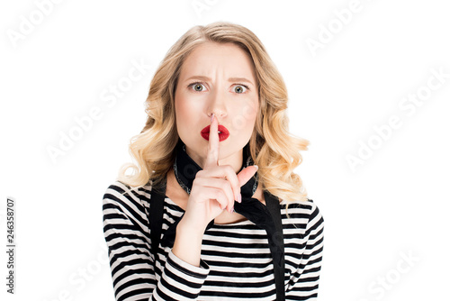 attractive woman holding finger on lips isolated on white