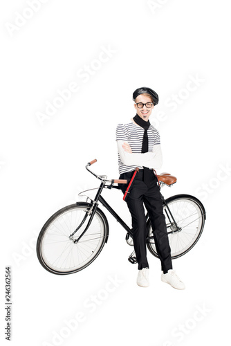 cheerful french man standing near bicycle isolated on white