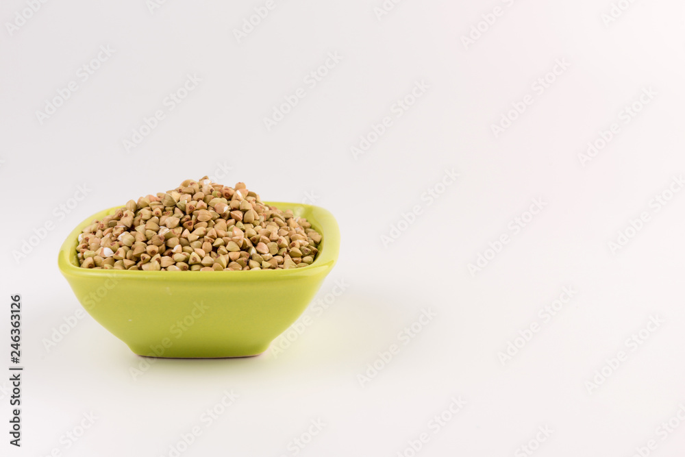 Natural fresh green buckwheat in bowl isolated on white background. Natural fresh green buckwheat in bowl isolated on white background.