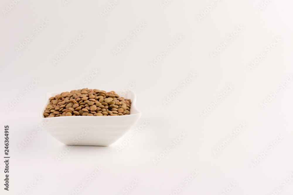 Yellow lentil in a bowl isolated on white background Yellow lentil in a bowl isolated on white background
