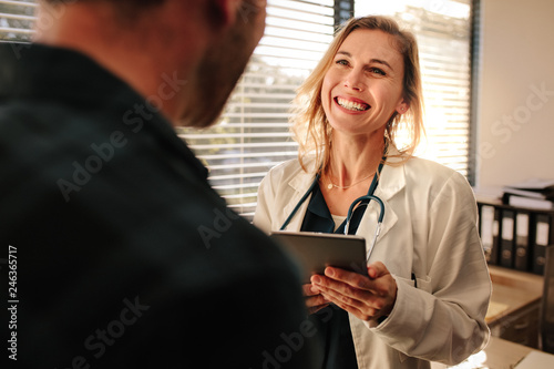 Friendly doctor interacting with her patient photo