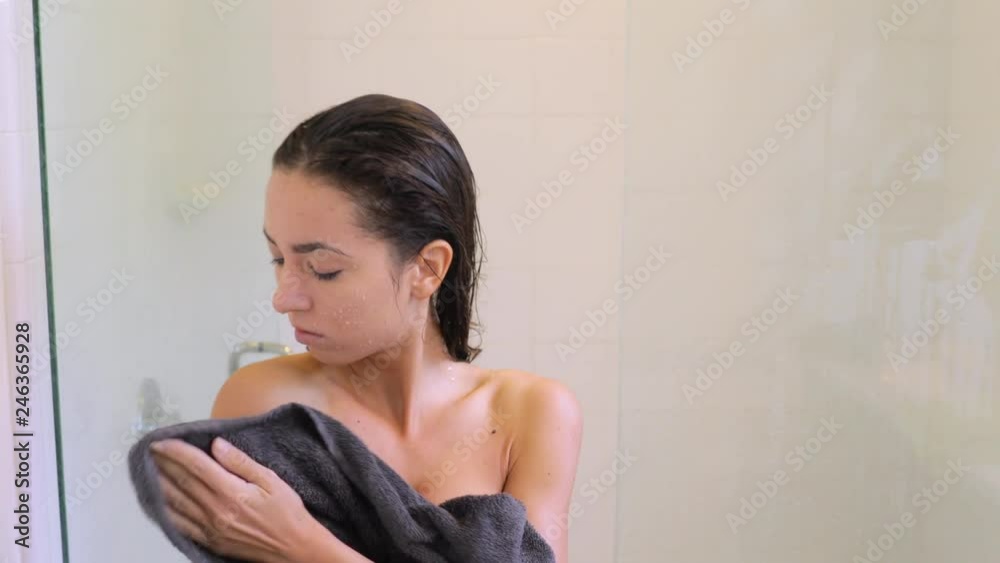 Attractive woman drying off aster taking her morning shower. Attractive woman drying off aster taking her morning shower.
