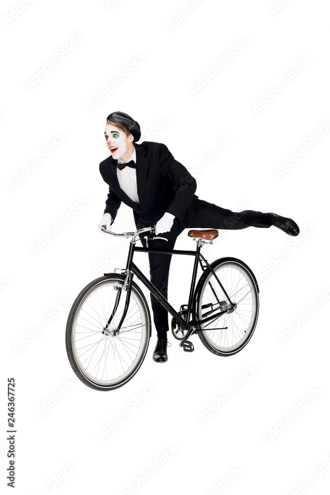 cheerful clown in suit riding bicycle isolated on white cheerful clown in suit riding bicycle isolated on white