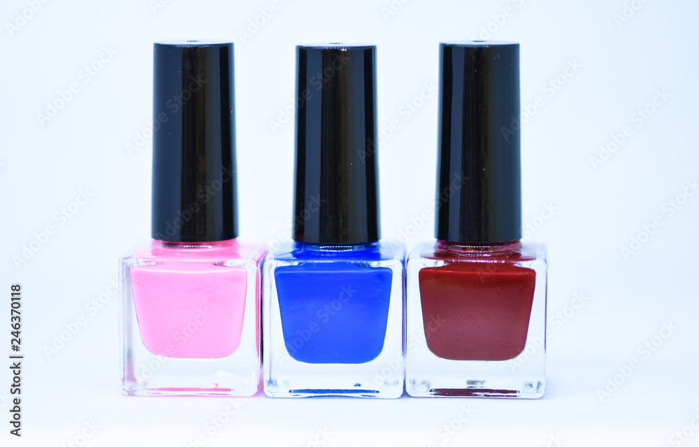 Beauty and care concept. Nail polish white background. Manicure salon. Durability and quality of nail polish coating. Gel polish modern technology. Fashion trend. Nail polish bottles different colors