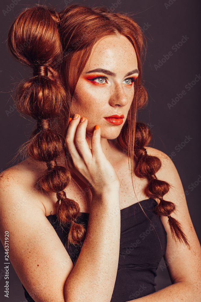 Fototapeta premium Ginger girl with professional make up on black background. Beauty, freckles concept