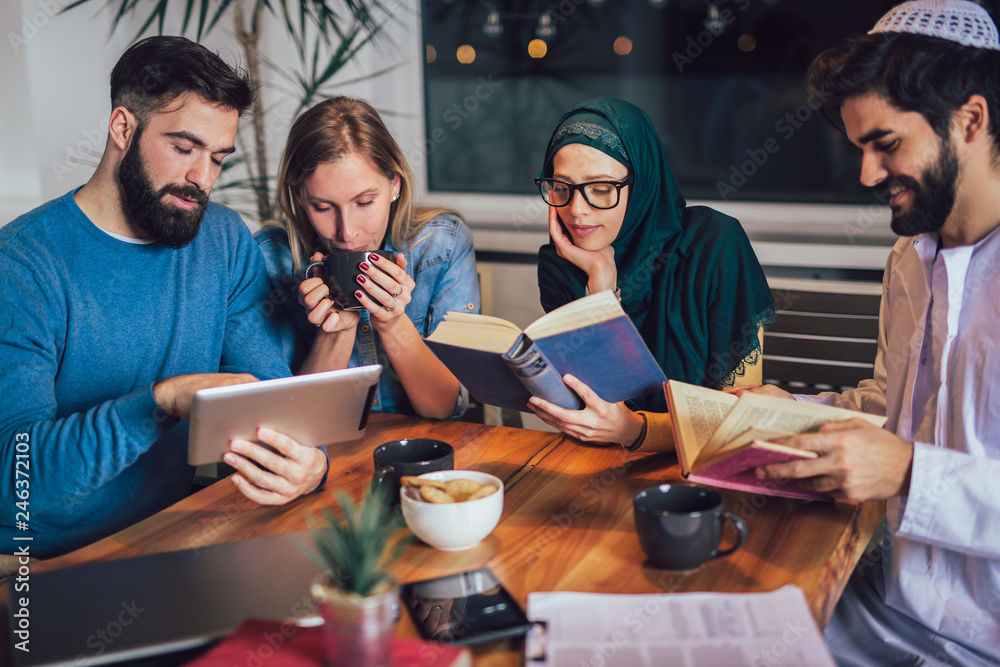 Group of students of diverse ethnic learning at home. Learning and preparing for university exam. Group of students of diverse ethnic learning at home. Learning and preparing for university exam.
