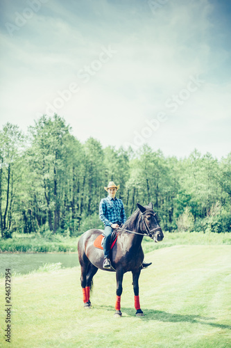 Brave man riding a horse in the farm in cowboy style. Sport, happiness, hobby concept