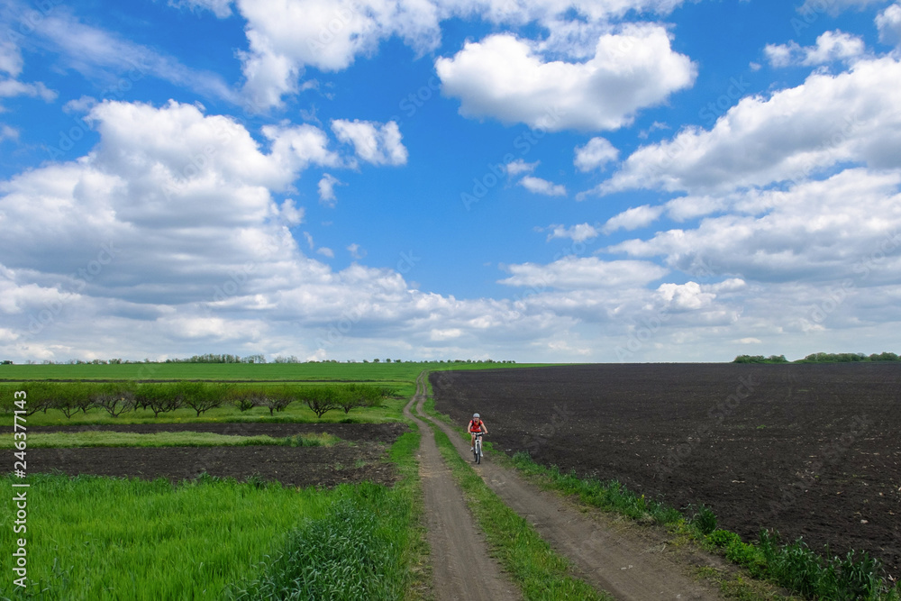 cyclist on road in the field