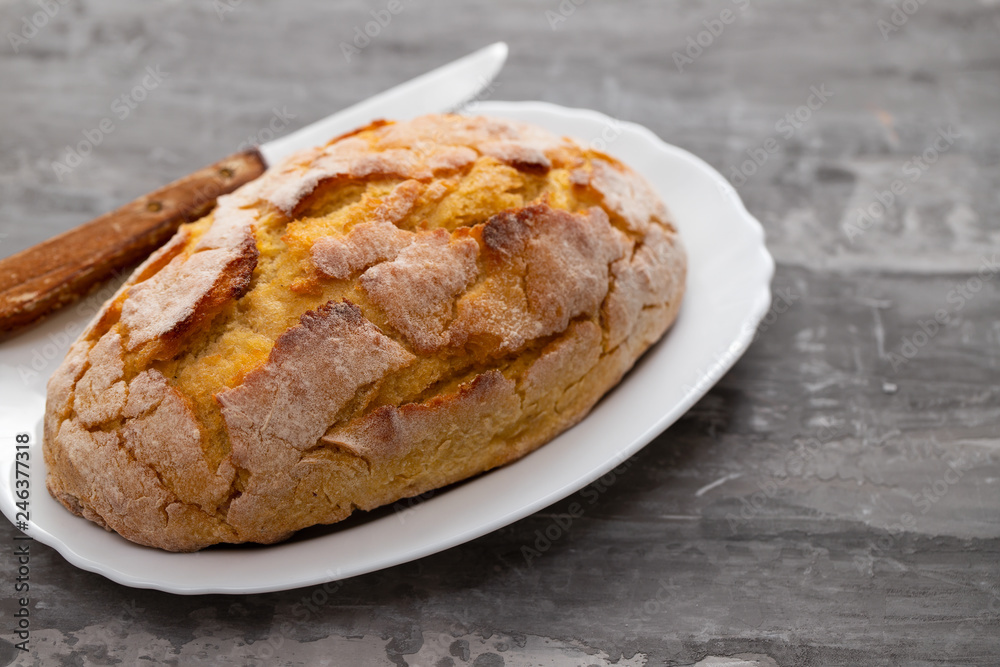 corn bread with knife on white dish