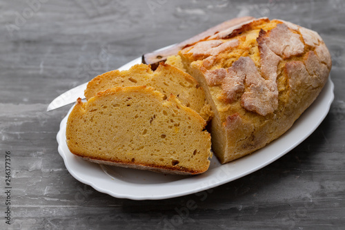 corn bread with knife on white dish