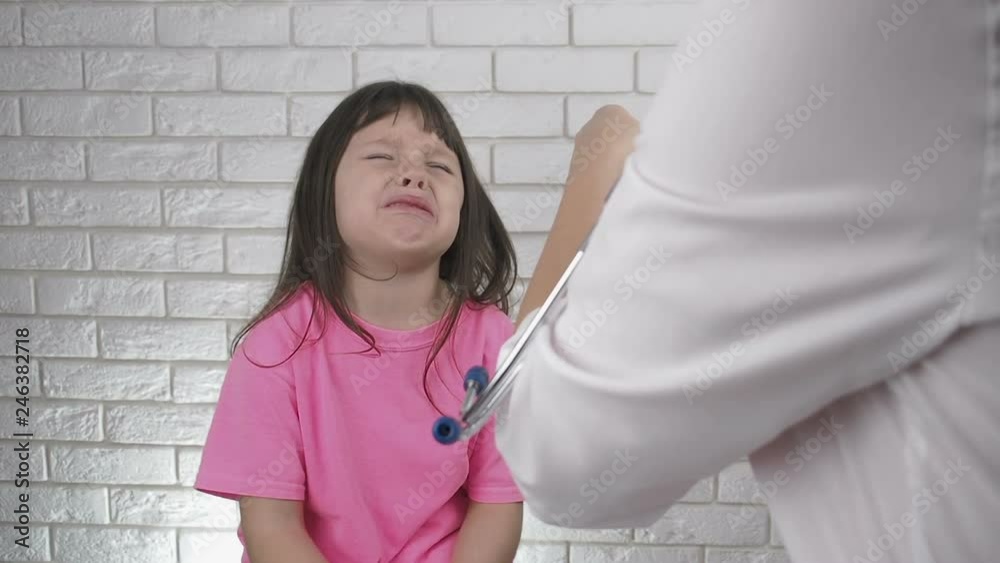 The doctor gives the child medication. The little girl doesn't want to take medicine. The doctor gives the child medication. The little girl doesn't want to take medicine.