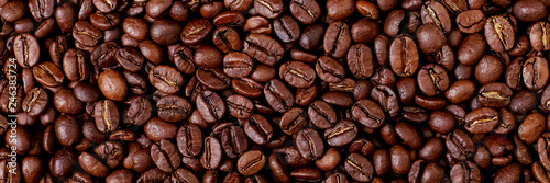 Aroma roasted coffee beans  brown banner background. Soft focus close up.