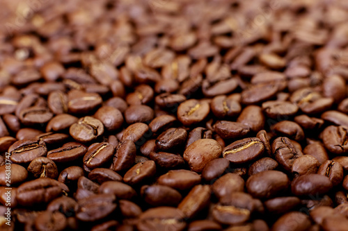 Aroma roasted coffee beans, brown background. Soft focus close up.
