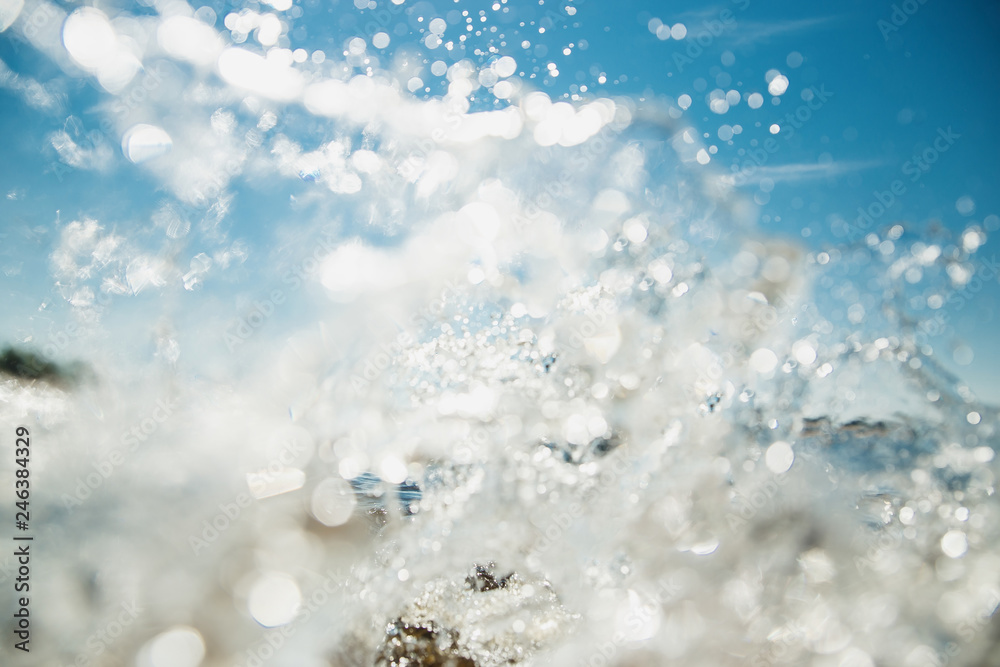 Summer swimming concept. Water splashes in sunlight and blue sky. Selective focused image. Summer swimming concept. Water splashes in sunlight and blue sky. Selective focused image.