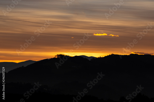 Beautiful romantic sunset in the mountains, black silhouette © sandradombrovsky
