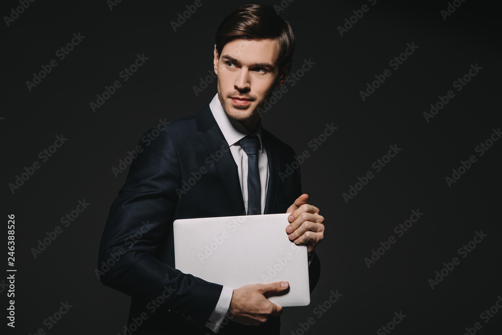 businessman in formal wear holding digital tablet isolated on black businessman in formal wear holding digital tablet isolated on black