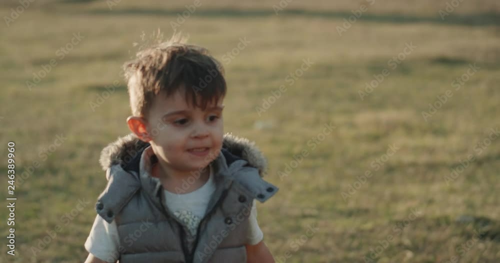 Funny cute little boy running in the middle filed in front of the camera Funny cute little boy running in the middle filed in front of the camera