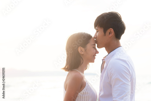 Happy romantic couple on the beach at sunset. Romantic and love concept.
