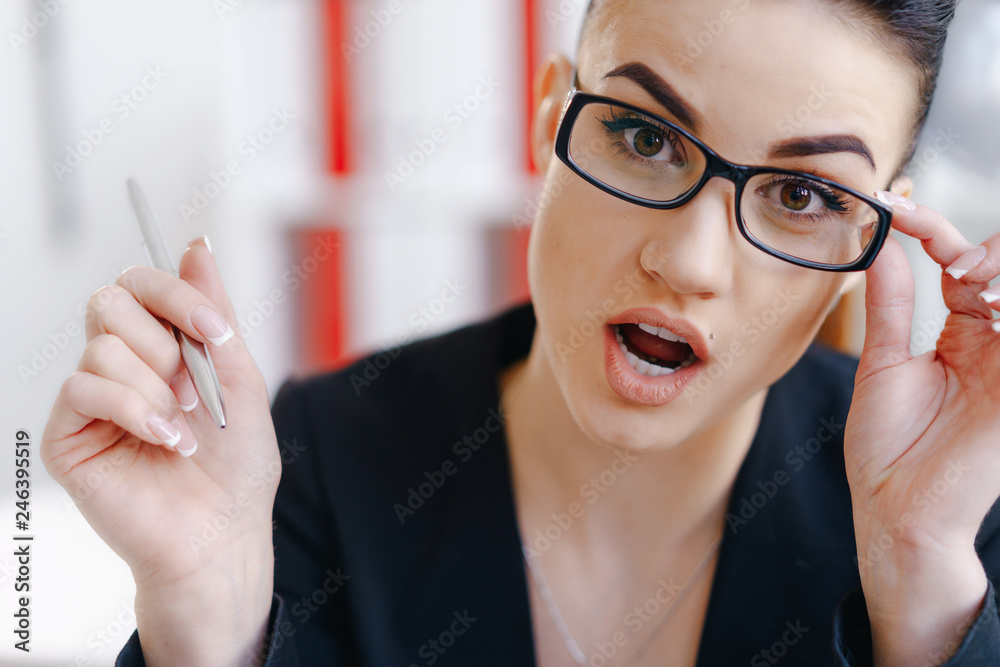Young beautiful business woman holding glasses