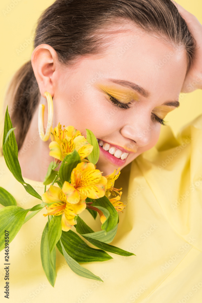 beautiful stylish girl with eyes closed and flowers posing isolated on limelight