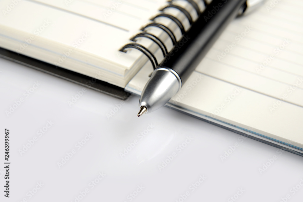 Note pad and ball pen on white background Note pad and ball pen on white background
