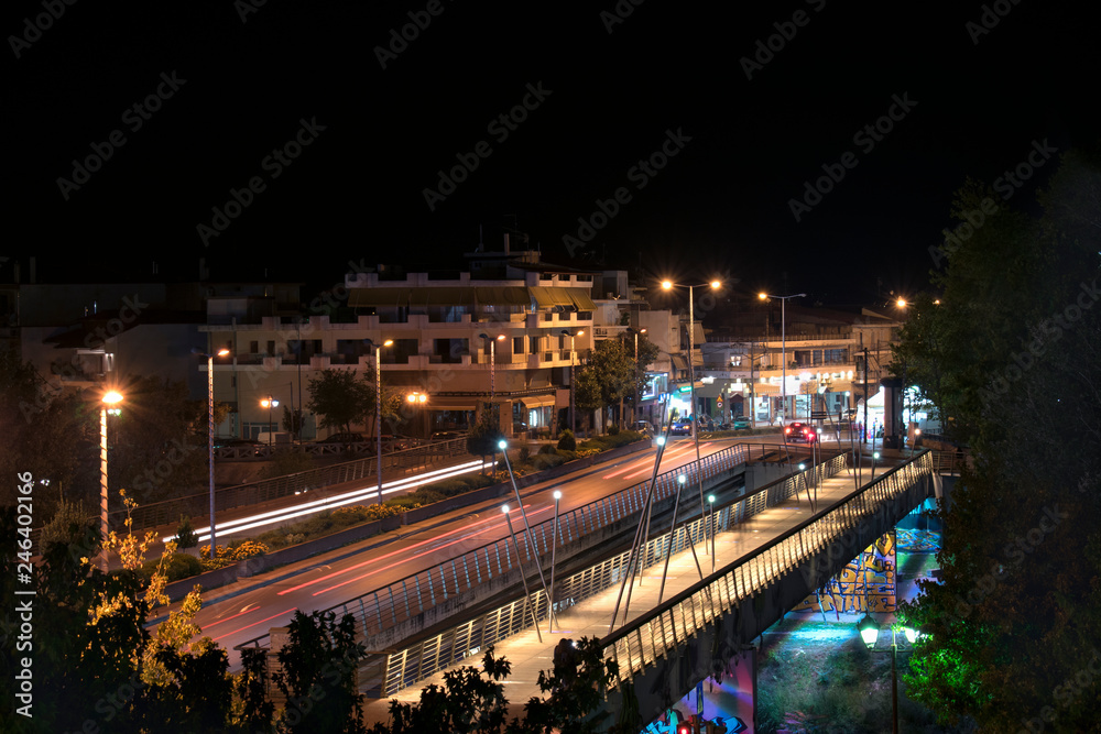 The bridge of the Pinios River in a night photo. Light painting from car lights. In the city of Larissa