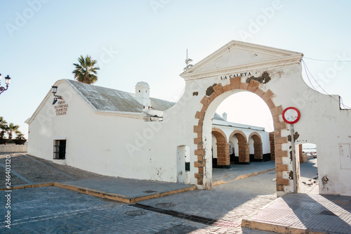 Entrance arch to the beach of La Caleta and Flamenco group Juanito Villar, Cádiz, Spain. photo