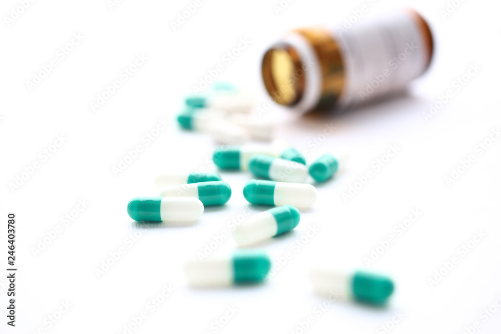 Pile of green and white pills arranged to scatter Pile of green and white pills arranged to scatter