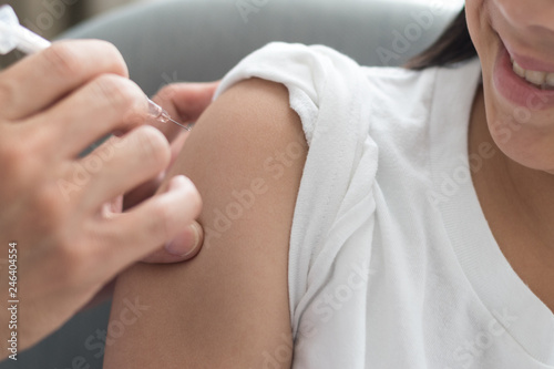 Wallpaper Mural World immunization week and International HPV awareness day concept.Strong happy healthy Asia kid girl get vaccination influenza, flu shot, HPV prevention with doctor pediatrician hold medical syringe Torontodigital.ca