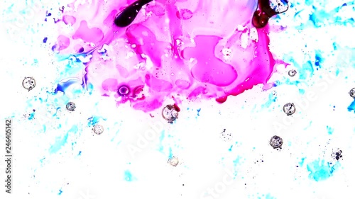 Ink is squashed in between 2 sheets of glass and spreads out creating colourful effects