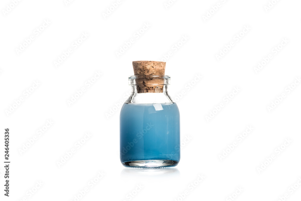 Studio shot of glass bottle with blue liquid isolated on white