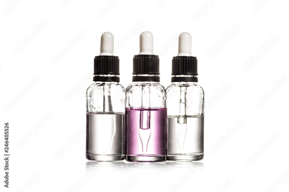 Studio shot of three glass bottles with serum isolated on white